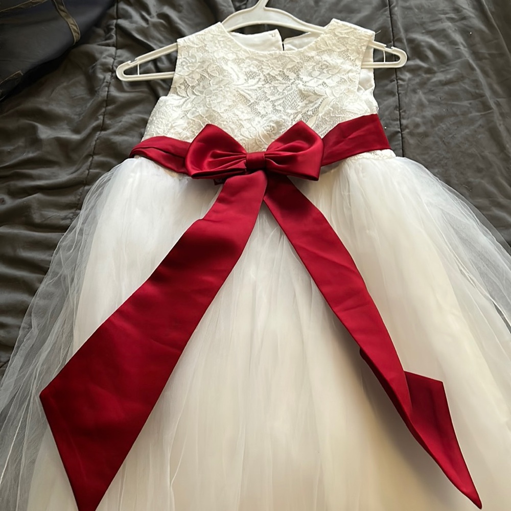 It’s my flower girl dress , it’s white with candy apple red bow.